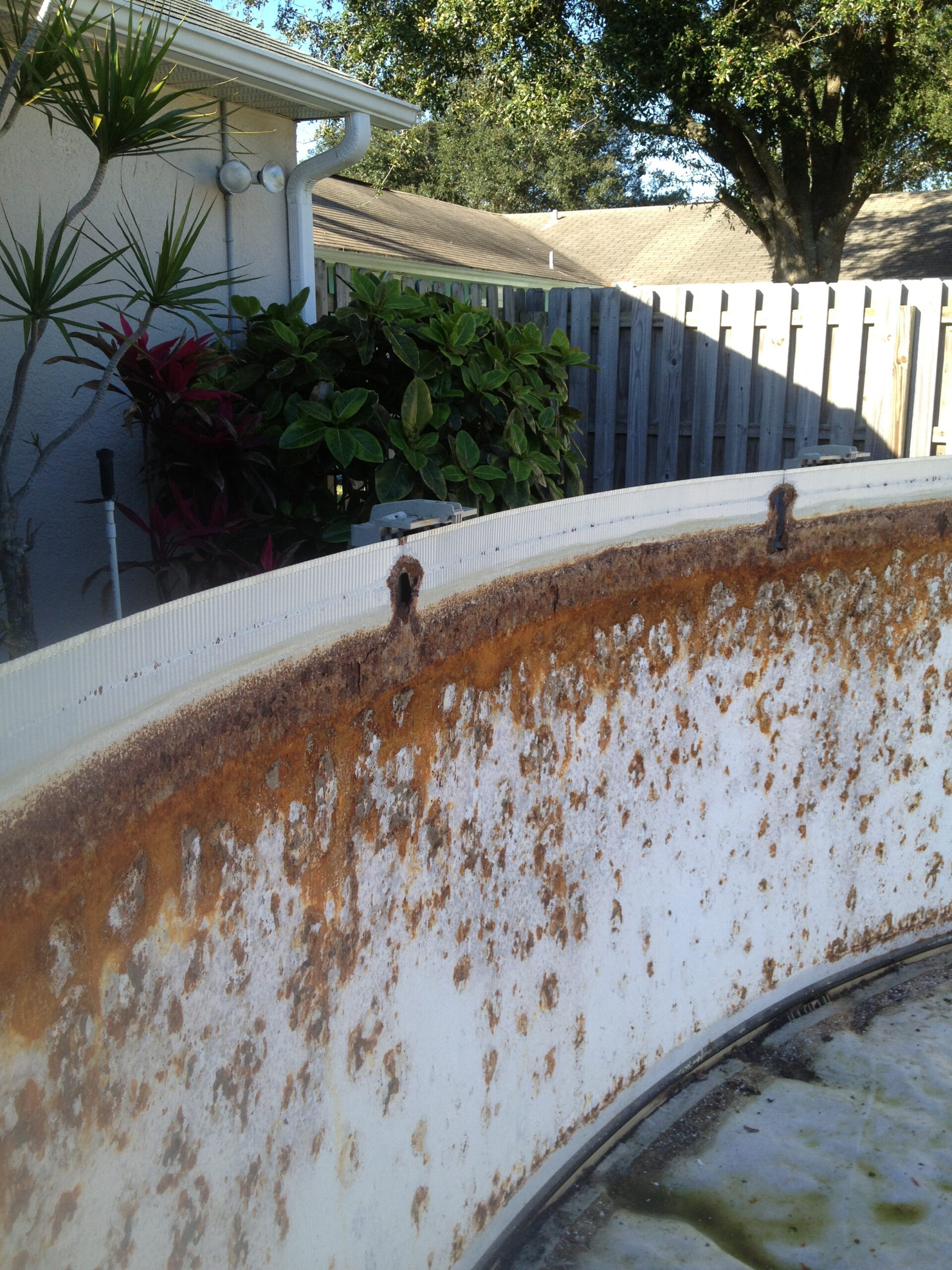 Rusted above ground pool wall due to the bead channel