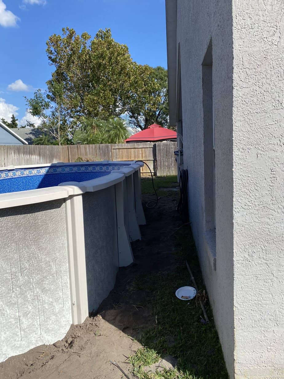 12x24 oval above ground pool in small yard