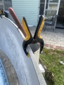 Spring clip to hold above ground pool wall