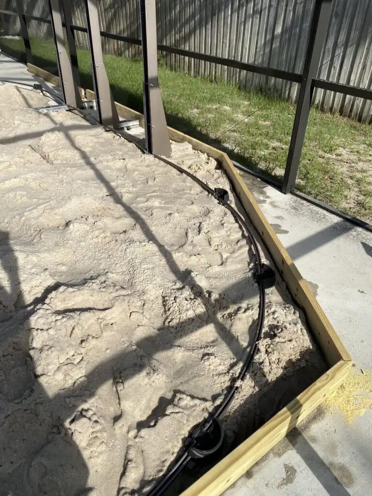 sand in a sandbox for oval above ground swimming pool