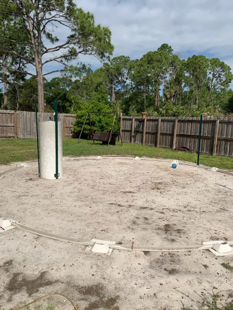 Bottom track of above ground pool is laid out in place and level