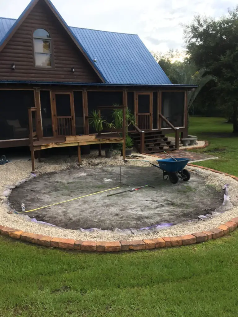 Existing above ground pool site with rocks and a small deck