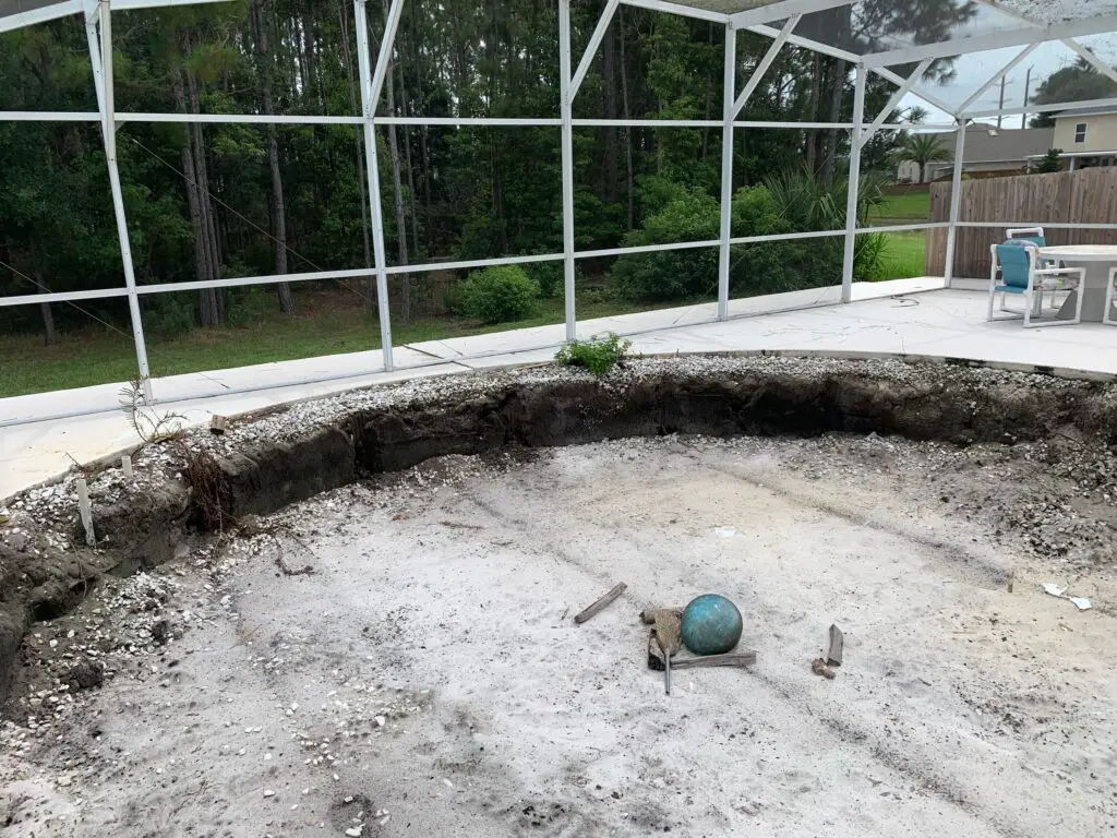 Hole dug in screen enclosure for an above ground swimming pool