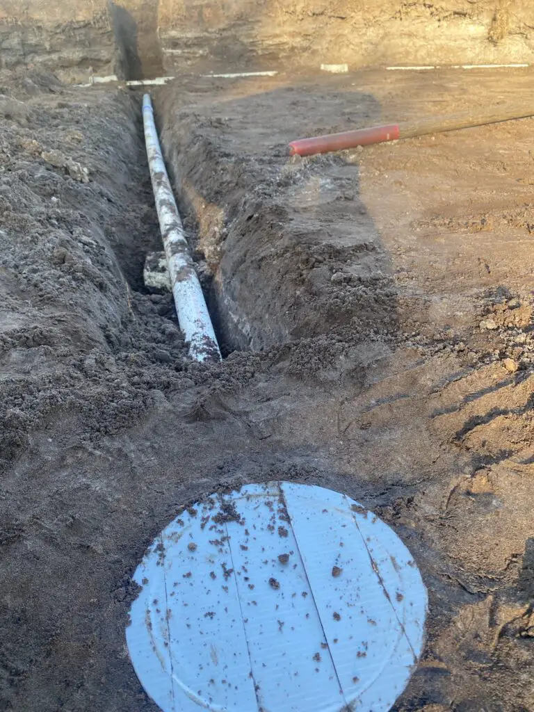 Above ground pool main drain set before burying the piping during installation