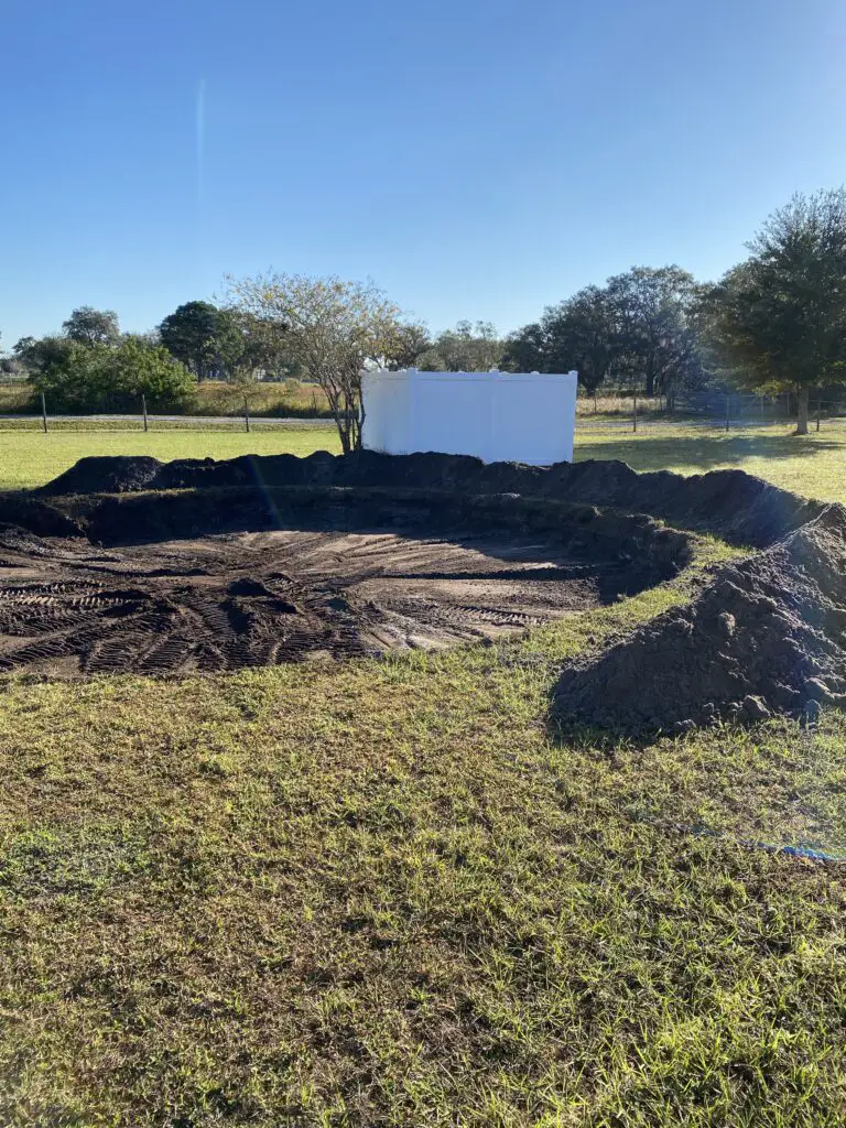 piles of dirt left around a hole dug to recess an above ground pool for easier backfilling