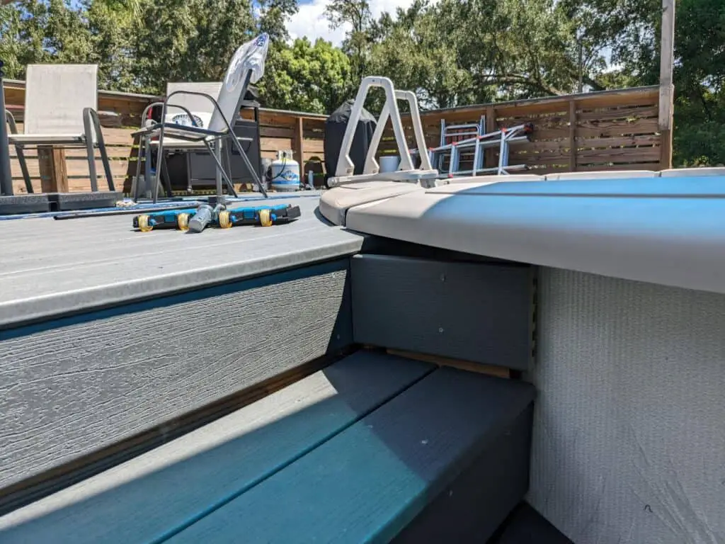 Composite deck next to an above ground pool with steps