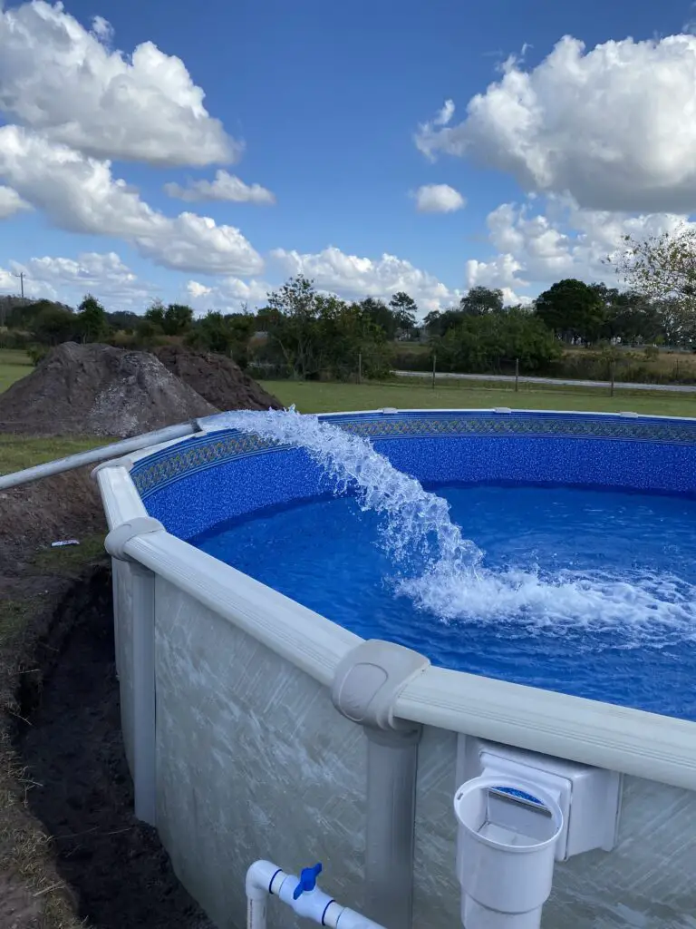 Water being pumped into a 24' round above ground pool from a water truck