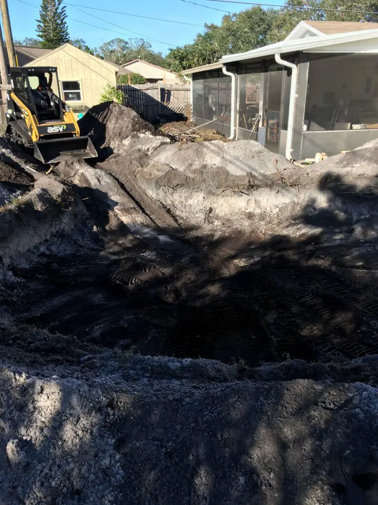 Hole dug in a backyard for a semi inground above ground pool 