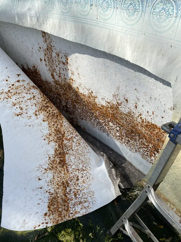 Rust from an above ground pool wall sticks to the inside of the liner