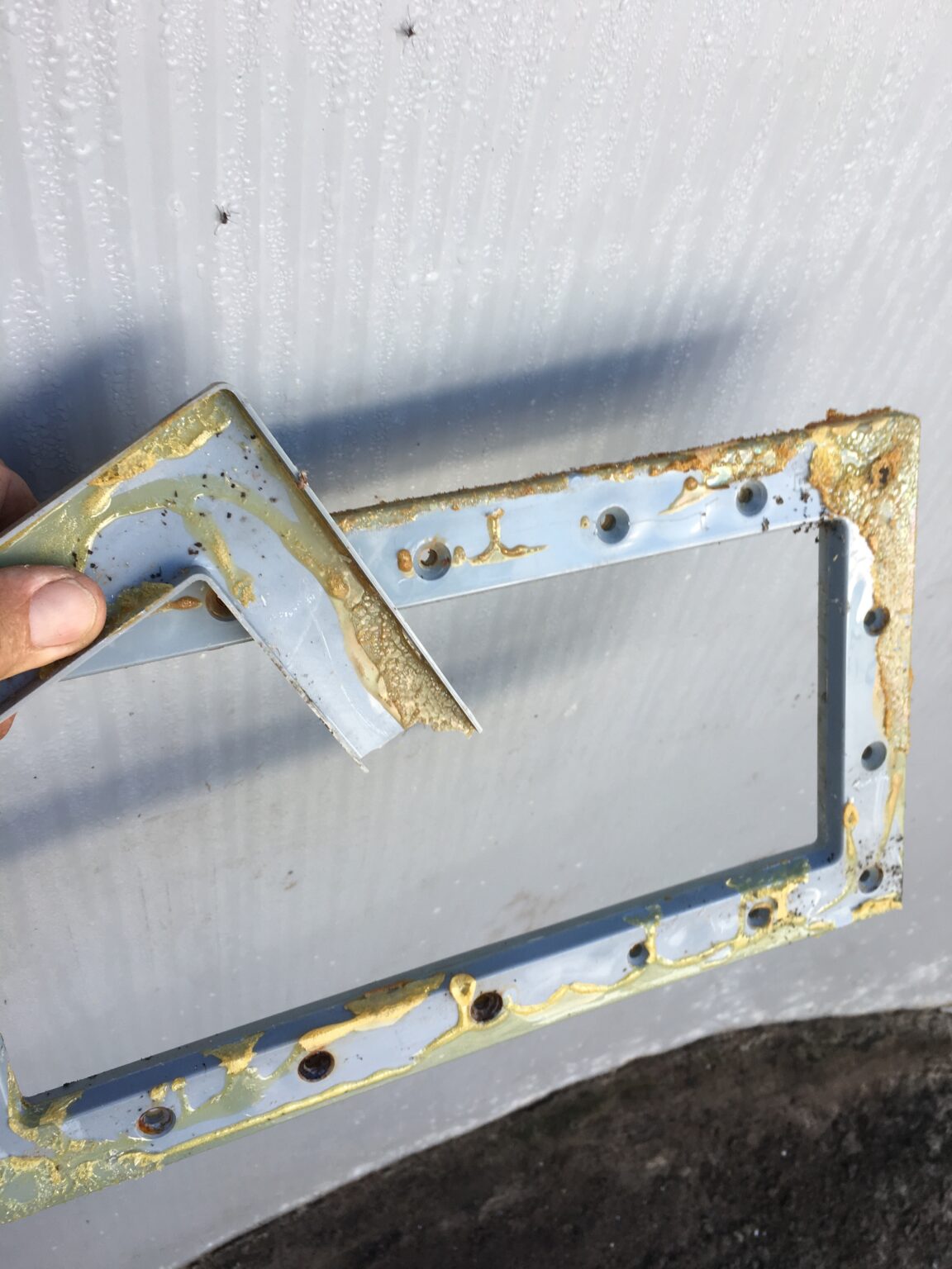 Example of a sealant ruining a skimmer faceplate