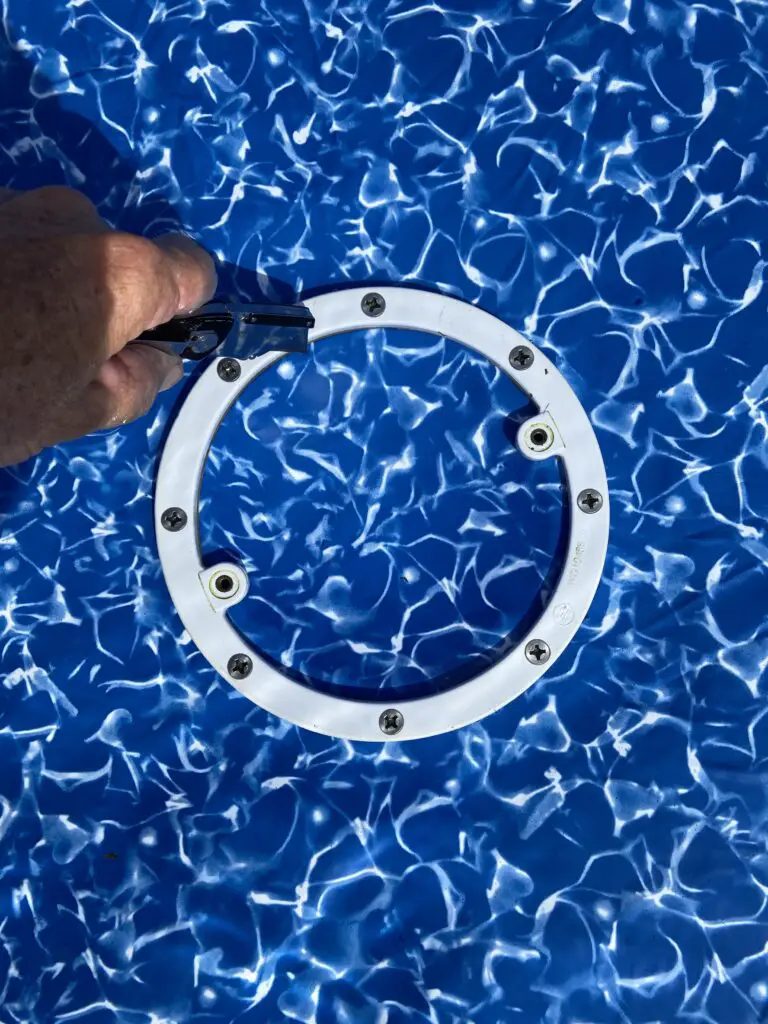 Cutting out the liner inside the opening of a main drain for an above ground pool