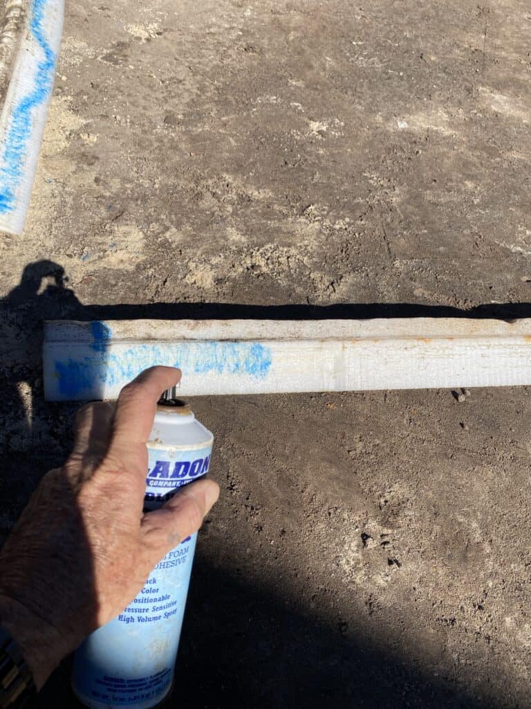 Spray on glue applied to a piece of used foam coving in an above ground pool
