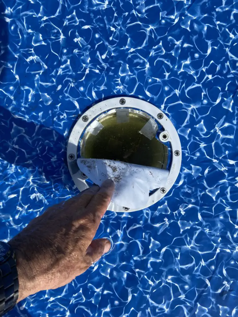 Cutting open the liner for a main drain in an above ground pool