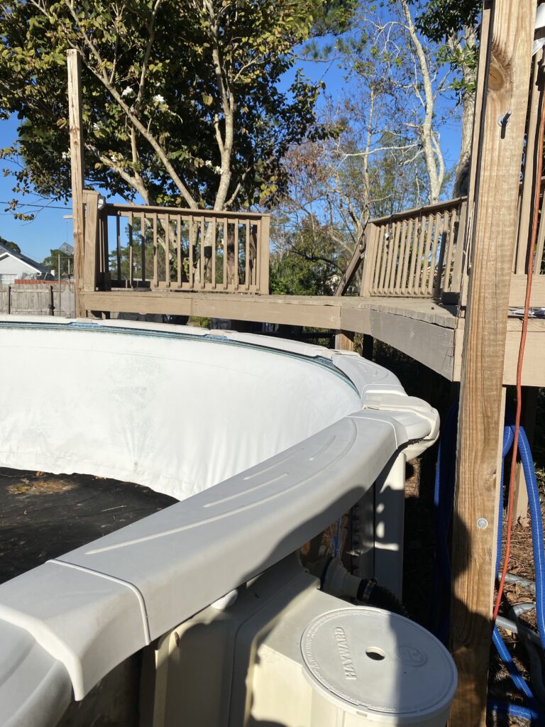 Wood deck built 10 inches over the top rails of an above ground swimming pool