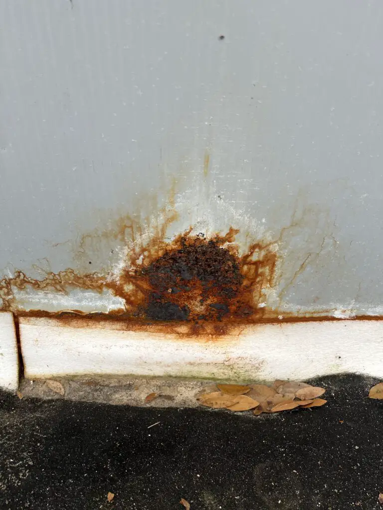 severe rust spot on above ground pool wall due to a leak