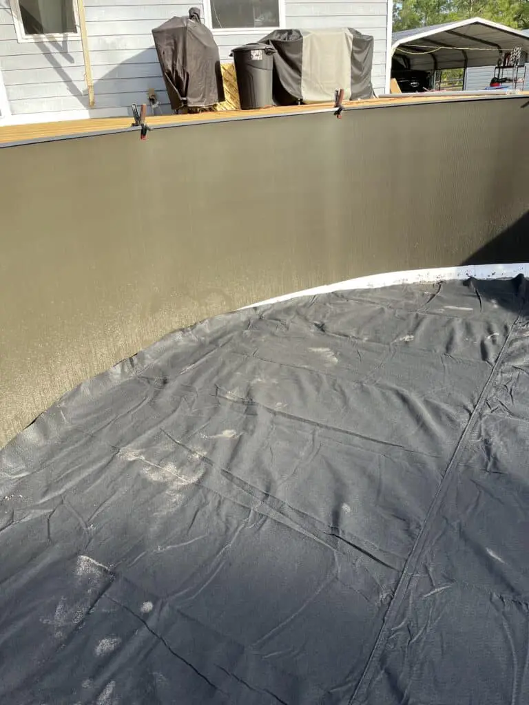 Liner guard laid out in an above ground pool before the liner is installed