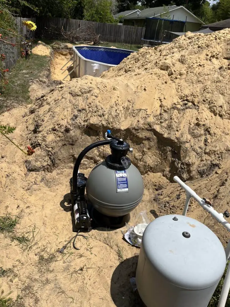 Above ground pool pump placed away from a semi-inground installation