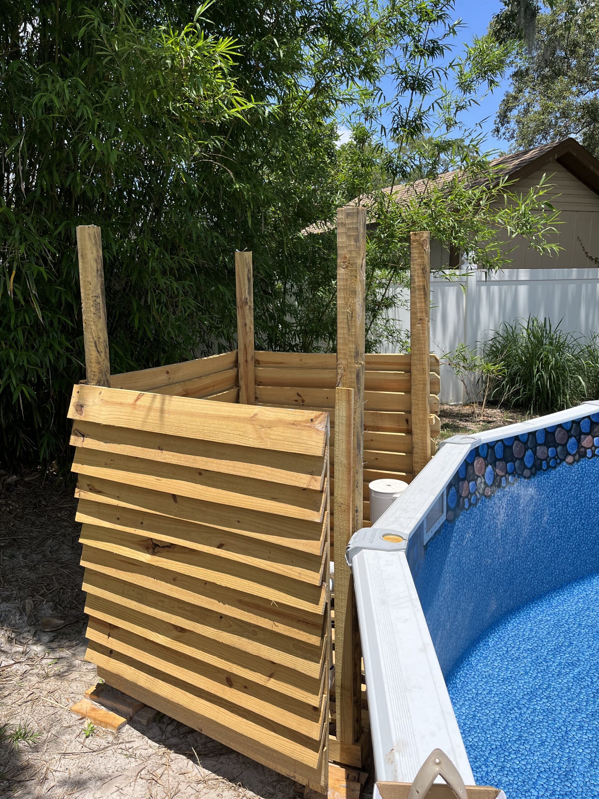Enclosed doghouse hiding the pump and filter for and above ground pool